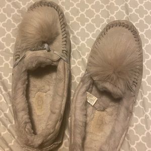 Grey Ugg house shoes with fur ball on top